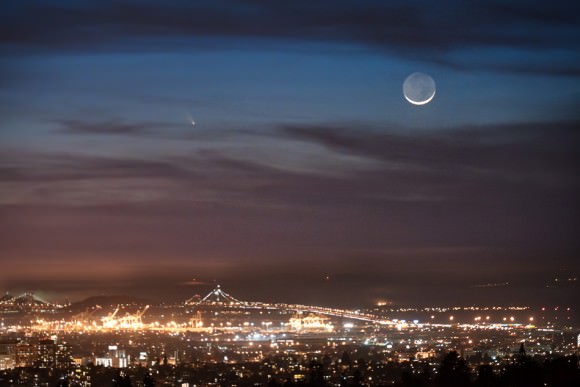 Comet PANSTARRS seen from Oakland, California.  The Port of Oakland and the Bay Bridge are in the foreground with the comet and crescent moon in the background. Taken on March 12, 2013. Credit and copyright: Jared Wilson.  