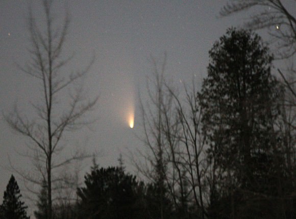 Comet PANSTARRS very low in the northwestern sky shortly before setting last night March 19. Details: 300mm lens, f2.8, ISO 3200 and about 4 seconds.  Credit: Bob King