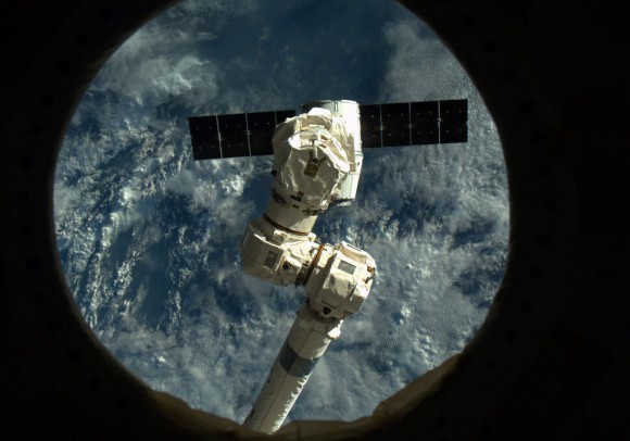 'Like a Praying Mantis, Canadarm2 poised to reach out and grab Dragon.' Credit: NASA/Chris Hadfield.
