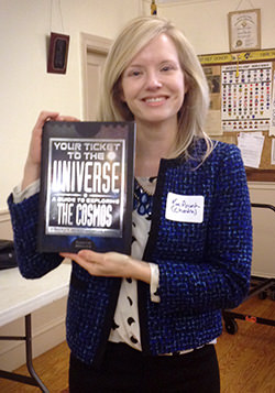Kim K. Arcand holds a copy of her book during a presentation at the Skyscrapers Astronomical Society of Rhode Island