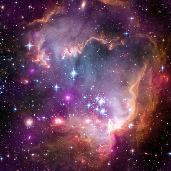 A part of the Small Magellanic Cloud galaxy is dazzling in this new view from NASA's Great Observatories. The Small Magellanic Cloud, or SMC, is a small galaxy about 200,000 light-years way that orbits our own Milky Way spiral galaxy. Credit: NASA.