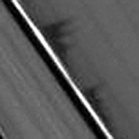 Daphnis' wake casts peaked shadows on the rings