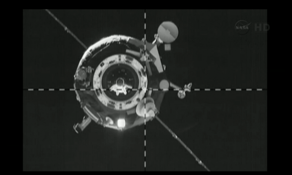 Progress 51 on final approach to the International Space Station. The stuck antenna is visible below the crosshairs. Credit: NASA TV (screencap)