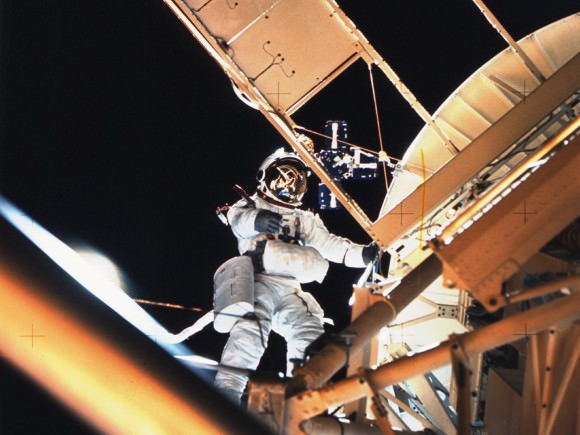 Owen Garriott Performs a Spacewalk During Skylab 3 Astronaut Owen Garriott performs a spacewalk at the Apollo Telescope Mount (ATM) of the Skylab space station cluster in Earth orbit, photographed with a hand-held 70mm Hasselblad camera. Garriott had just deployed the Skylab Particle Collection S149 Experiment. The experiment was mounted on one of the ATM solar panels. The purpose of the S149 experiment was to collect material from interplanetary dust particles on prepared surfaces suitable for studying their impact phenomena. Earlier during the spacewalk, Garriott assisted astronaut Jack Lousma, Skylab 3 pilot, in deploying the twin pole solar shield.  Credit: NASA 