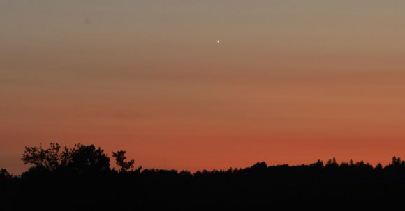 Venus punctuates colorful clouds low in the west in August 2008. Credit: Bob King