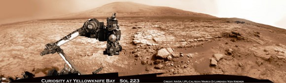 Curiosity and Mount Sharp: Curiosity's elevated robotic arm and drill are staring back at you - back dropped by Mount Sharp, her ultimate destination.  The rover team anticipates new science discoveries following the resumption of contact with NASA after the end of solar conjunction.  This panoramic vista of Yellowknife Bay basin was snapped on March 23, Sol 223 prior to conjunction and assembled from several dozen raw images snapped by the rover's navigation camera system.  These images were snapped after the robot recovered from a computer glitch in late Feb and indicated she was back alive and functioning working normally. Credit: NASA/JPL-Caltech/Marco Di Lorenzo/KenKremer (kenkremer.com).  