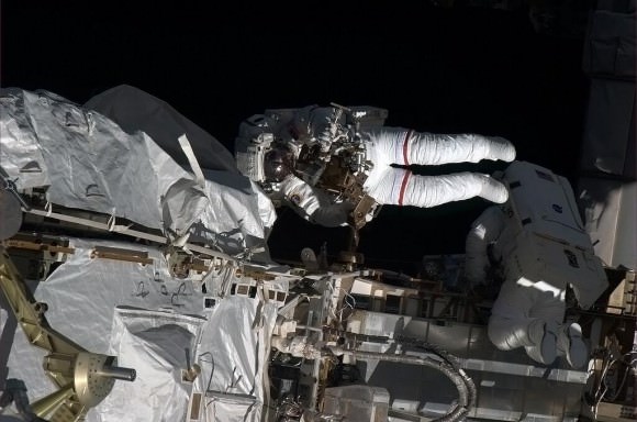 Cassidy and Marshburn work outside the ISS in the 'approaching orbital sunset, the harshest of light, a blackness like endless velvet,' said Hadfield. Credit: NASA/CSA/Chris Hadfield. 