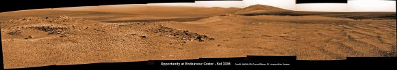 Opportunity captures spectacular panoramic view ahead to her upcoming mountain climbing goal, the raised rim of “Solander Point” at right, located along the western edge of Endeavour Crater. It may harbor clay minerals indicative of a habitable zone.  The rise at left is "Nobbys Head" which the rover just passed on its southward drive to Solander Point from Cape York.  This pancam photo mosaic was taken on Sol 3335, June 11, 2013 shows vast expanse of the central crater mound and distant Endeavour crater rim.   Credit: NASA/JPL/Cornell/ASU/Marco Di Lorenzo/Ken Kremer (kenkremer.com) See full panoramic scene below