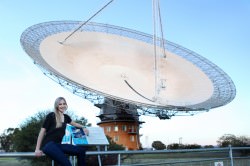 Jacinta Delhaize with CSIRO's Parkes Radio Telescope during one of her data collecting trips. Credit: Anita Redfern Photography.