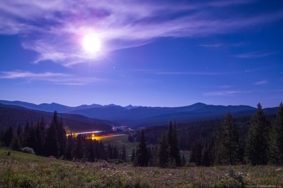 The full-moon illuminated landcape, overlooking Interstate 70, near Vail, Colorado. Credit and copyright: Cory Schmitz. 