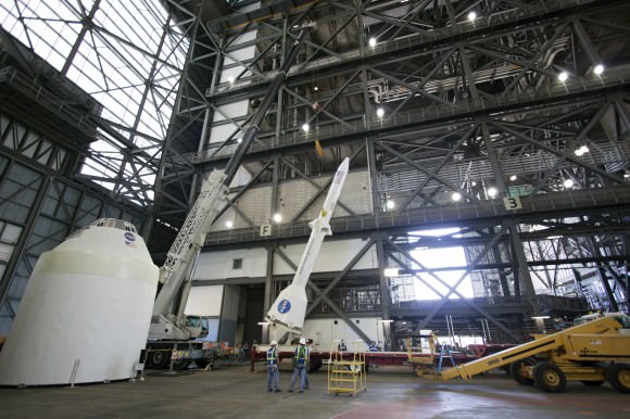 Technicians at work practicing de-stacking operations with full size mockups of the Orion capsule and Launch Abort System components inside the Vehicle Assembly Building at the Kennedy Space Center in Florida. Credit: /Jim Grossmann