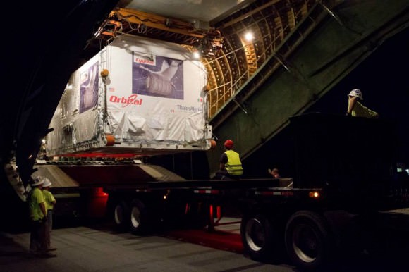 Cygnus stored inside shipping container is unloaded from Antonov An-124 aircraft after arrival at NASA Wallops, VA on July 17, 2013. Credit:  NASA/Patrick Black