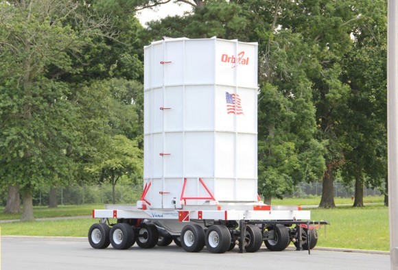 Cygnus spacecraft is loaded onto the Cygnus Vertical Carrier (CVC)  16-wheeled transporter to move between processing facilities at NASA’s Wallops Island launch site. Credit: Ken Kremer (kenkremer.com)
