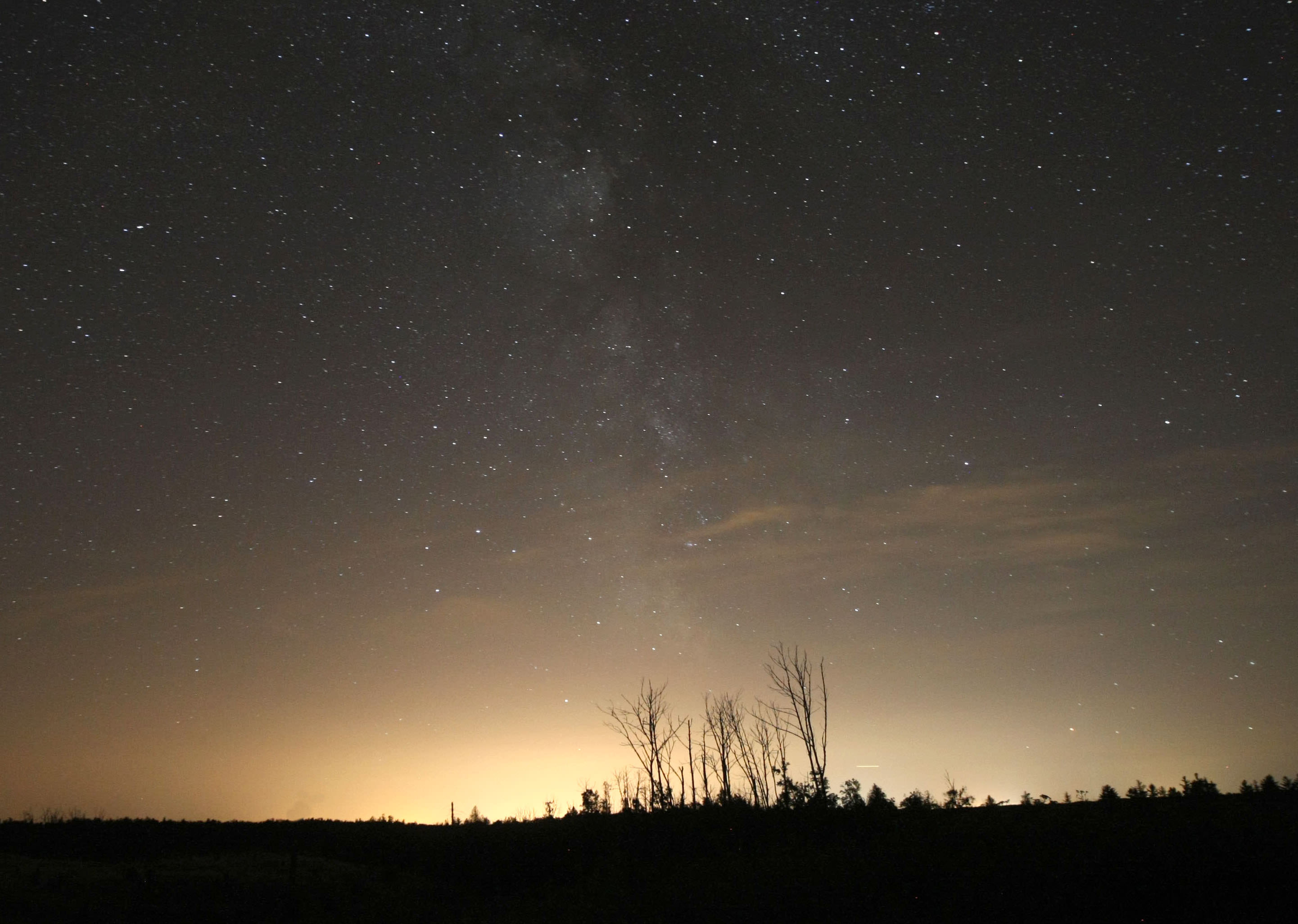 Urban sprawl and accompanying light pollution is an issue for both astronomers and fireflies. This view shows the light dome from the city of Duluth, Minn. 20 miles north of town. It erases the dark skies. Credit: Bob King