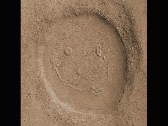 Those Martians obviously have a sense of humor. This 2-mile-wide (3 km) unnamed crater was photographed in 2008 by the Mars Reconnaissance Orbiter.