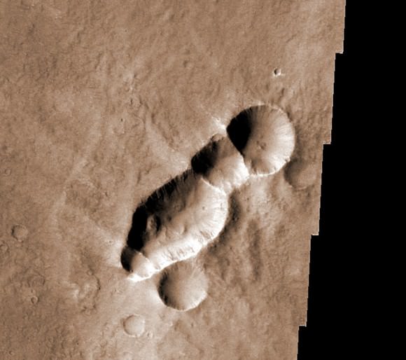 This crater chain with its wispy "wings" of impact debris resembles a wasp. The feature was most likely created when a meteorite coming it at a very low angle broke into pieces just before impact.
