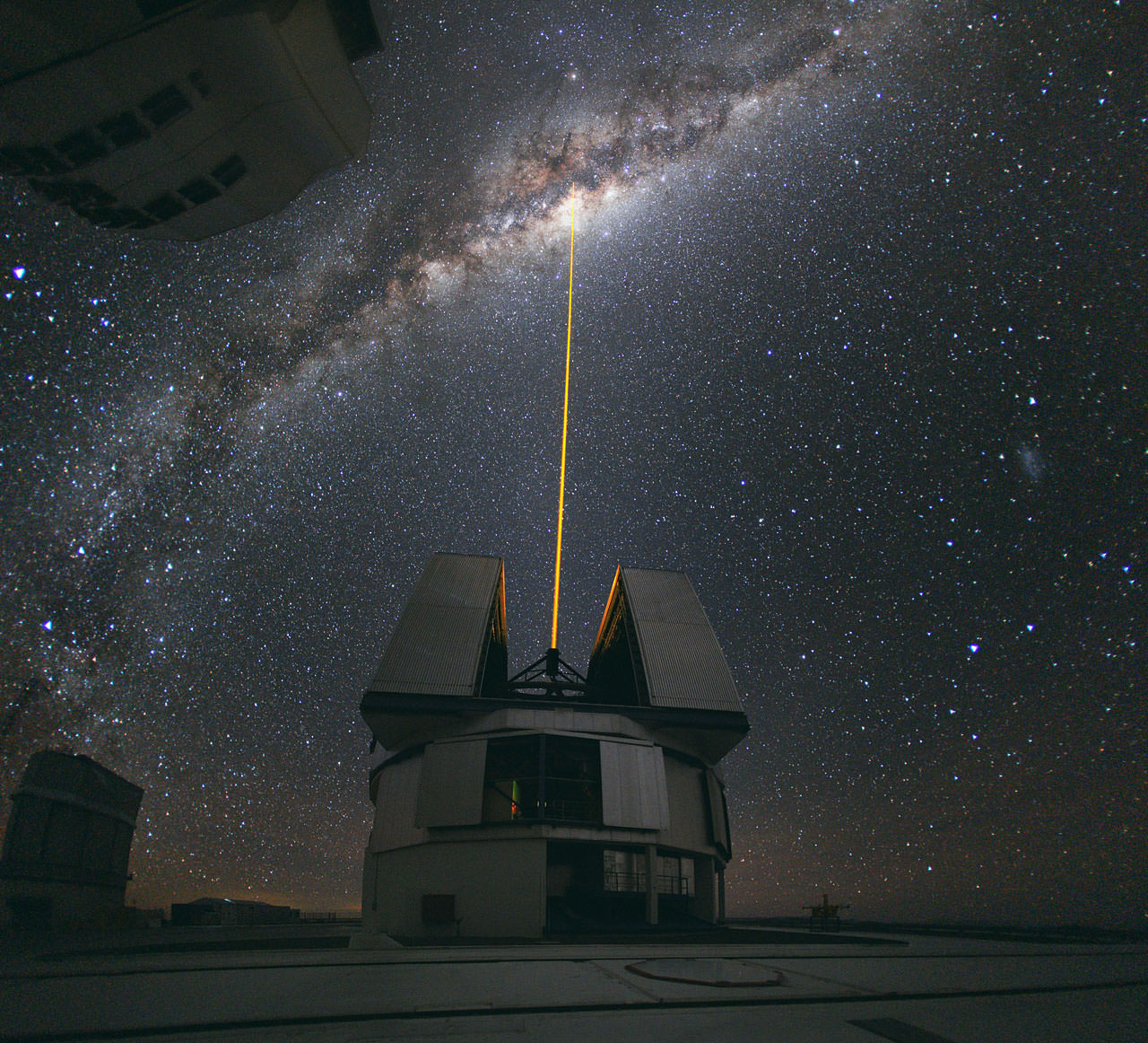 Lasers like this one, at the VLT in Paranal, help counteract the blurring effect of the atmosphere. Powerful arrays of much larger lasers could hide our presence from aliens. (ESO/Y. Beletsky)