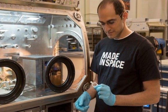 Deputy Program Manager Matthew Napoli examines a 3D printed piece at Marshall Space Flight Center. Image courtesy Made In Space. 