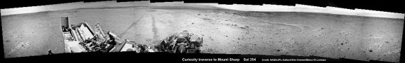 NASA’s Curiosity rover make tracks to Mount Sharp (at left) across the floor of Gale Crater. The rover paused to image the windblown ripple at right, below the hazy crater rim. The wheel tracks are about eight  feet apart. This panoramic mosaic was assembled from a dozen navcam camera images taken on Sol 354 (Aug 4, 2013. Credit: NASA/JPL-Caltech/Ken Kremer Marco Di Lorenzo 