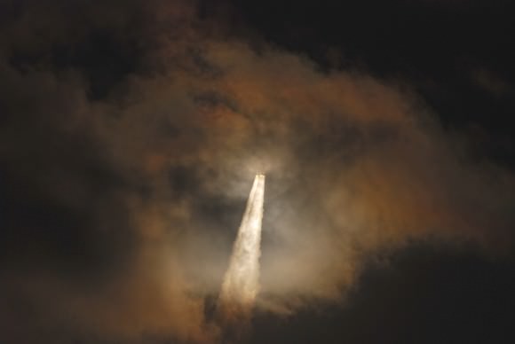 Through a cloud on its way to orbit, the Atlas 5 - 531 vehicle and it AEHF-3 payload dapple the clouds with light....  Credit and copyright: John O'Connor/nasatech.net.