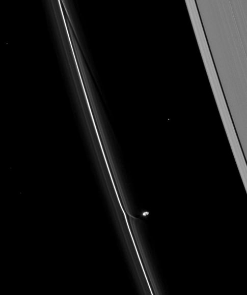 Prometheus, a small potato-shaped moon of Saturn, shown in this Voyager 1 picture interacting with the planet's F ring. Credit: NASA/JPL/SSI