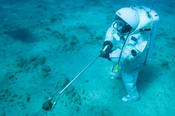 ESA astronaut Jean-François Clervoy collecting a rock sample underwater off the coast of Marseille, France. He was simulating the Apollo 11 mission underwater  to prepare for future missions to the Moon, Mars or an asteroid. Credit: Alexis Rosenfeld