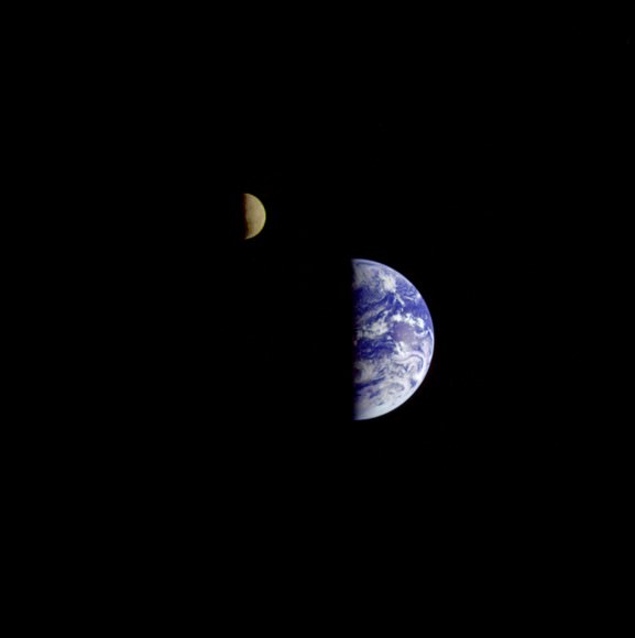 On Sept. 18, 1977, Voyager 1 took three images of the Earth and Moon that were combined into this one image. The moon is artificially brightened to make it show up better. Credit: NASA