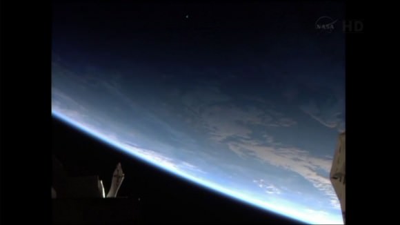 The ATV-4 is just visible as it passes into Earth's terminator. Credit: NASA TV. 