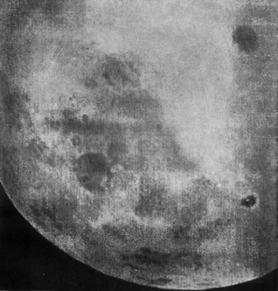 Telephoto image of Mare Moscoviense is at upper right with Tsiolkovsky and its bright central peak at lower right. You can start to see vague outlines of many more craters in this view. Click for more historic photos. Credit: Roscosmos
