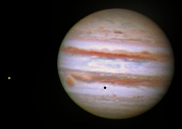 Jupiter on Sept. 24 with its moon Europa (at left) casting a pinhead black shadow on Jupiter's clouds. Credit: John Chumack