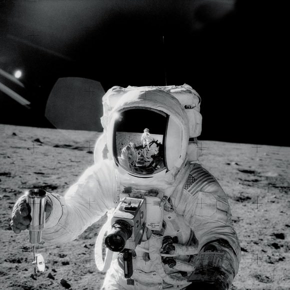 Apollo 12's Pete Conrad is visible in the helmet of crewmate Al Bean during their moon landing in November 1969. Credit: NASA