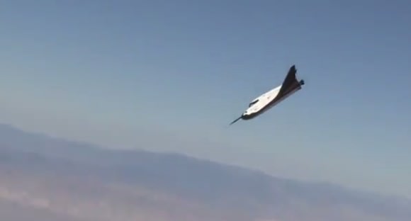 Following helicopter release the private Dream Chaser spaceplane starts glide to runway at Edwards Air Force Base, Ca. during first free flight landing test on Oct. 26, 2013 - in this screenshot.   Credit: Sierra Nevada Corp.  