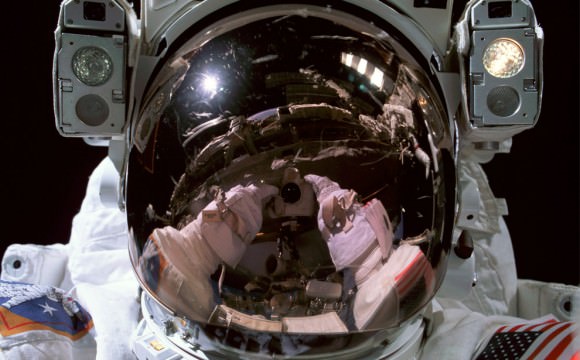 Expedition 6's Don Pettit takes a portrait in January 2003. Also visible in the picture (upper right) is his crewmate, Ken Bowersox. Credit: NASA