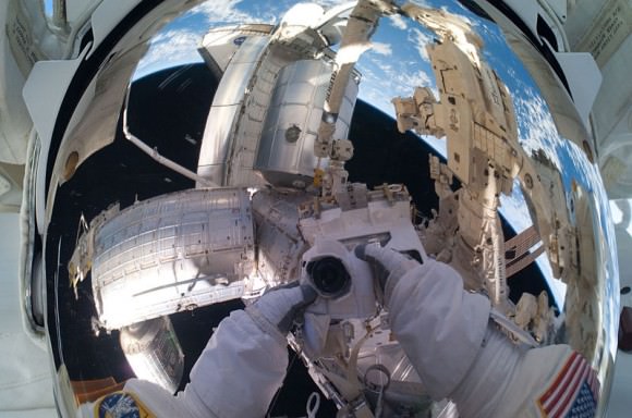 NASA astronaut Mike Fossum grabbed this self-portrait in July 2011, with space shuttle Atlantis visible in the background. Credit: NASA