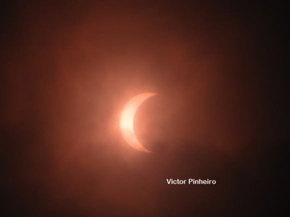 This image of the Nov. 3, 2013 solar eclipse was taken from the city of Espargos on the island of Sal, one of the island that make up the archipelago of the Republic of Capo Verde, off the coast of Africa.  Equipment: Canon PowerShot SX10 IS, with window film to reduce light. Credit and copyright: Victor Pinheiro.