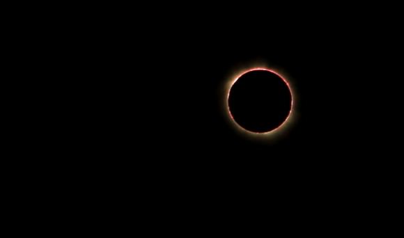 The moment of totality of the Nov. 3, 2013 solar eclipse, as viewed from Owiny Village in Uganda.  The photo was taken with a Canon Rebel T1i camera, using a Tamron f/2.8 28-75mm lens, unfiltered. Credit and copyright: Helen Lin.