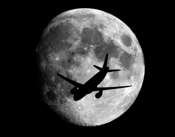 An airplane at about 2,400 meters above the ground  passes in front of the Moon on its way to landing at the Charles de Gaulle Airport in Paris, France. Taken from about 70 km from Paris. Credit and copyright: Sebastien Lebrigand.