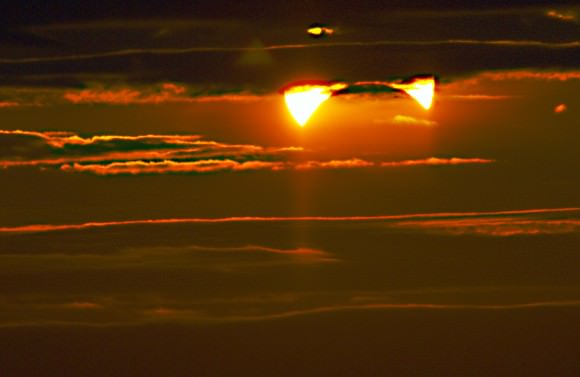 The partially eclipsed Sun disappearing into the clouds, as seen from New York City, Nov. 3, 2013 at 6:30 A.M. Credit and copyright: Ben Berry.  