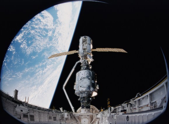 A space station is born. The Russian Zarya module (top) is connected to the U.S. Unity module using the Canadarm on Dec. 6, 1998. Shot is a still from an IMAX camera carried on board shuttle Endeavour. Credit: NASA
