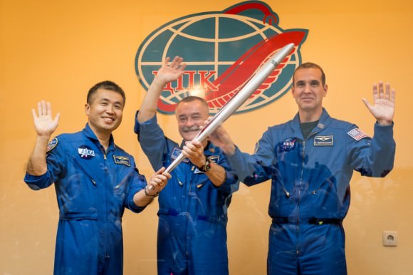 Expedition 38/39 poses with the Olympic torch that they brought into orbit with them in November 2013 as part of the relay for the 2014 Games in Sochi, Russia. From left, Koichi Wakata of the Japan Aerospace Exploration Agency, Mikhail Tyurin of Roscosmos, and Rick Mastracchio of NASA. Credit: NASA/Bill Ingalls