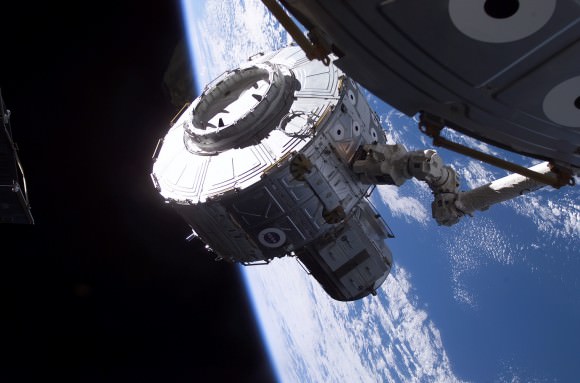 With NASA Expedition 2 astronaut Susan Helms controlling Canadarm2, the Quest airlock is brought over for installation on Unity Node 1 aboard the International Space Station. Today, Quest is the usual departure point for U.S. spacewalks. Credit: NASA
