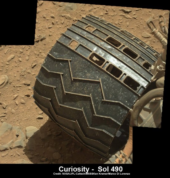 Up close view shows a tear in one of rover Curiosity’s six wheels caused by recent driving over rough Martian rocks. Mosaic assembled from Mastcam raw images taken on Dec. 22, 2013 (Sol 490) Credit: NASA/JPL/MSSS/Ken Kremer -kenkremer.com/Marco Di Lorenzo