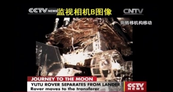 Yutu moves towards drive off ramp still atop the Chang’e-3 lander, shown in this screen shot from early Dec. 15, 2013.  Credit: CCTV