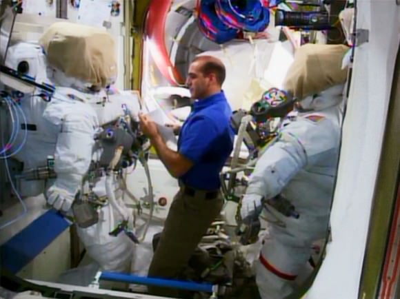 NASA astronaut Rick Mastracchio inspects two spacesuits to be used during spacewalks in December 2013. The spacewalks were to remove and replace a faulty ammonia pump. Credit: NASA TV