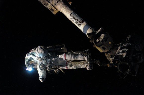 NASA astronaut Doug Wheelock anchored to Canadarm2 during an August 2010 spacewalk. He and Tracy Caldwell Dyson ventured outside three times during Expedition 24 to swap out and replace a broken ammonia pump. Credit: NASA