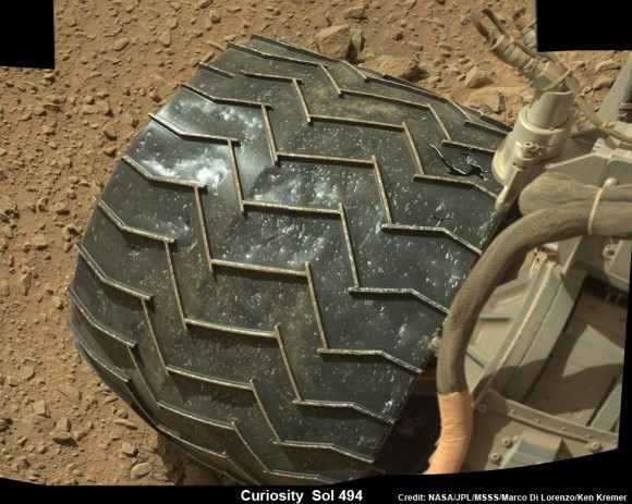Up close view of puncture in one of rover Curiosity’s six wheels caused by recent driving over rough Martian rocks. Mosaic assembled from Mastcam raw images taken on Dec. 26, 2013 (Sol 494) Credit: NASA/JPL/MSSS/Ken Kremer -kenkremer.com/Marco Di Lorenzo 