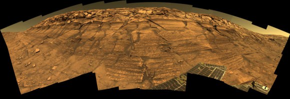 'Burns Cliff' Color Panorama Opportunity captured this view of "Burns Cliff" after driving right to the base of this southeastern portion of the inner wall of "Endurance Crater." The view combines frames taken by Opportunity's panoramic camera between the rover's 287th and 294th martian days (Nov. 13 to 20, 2004). The mosaic spans more than 180 degrees side to side. Credit: NASA/JPL-Caltech/Cornell