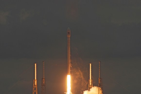 Almost clear of the catenary wires, the Thaicom 6/Falcon 9 mission streaks to orbit. Credit: nasatech.net