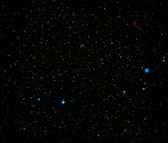 NuSTAR identifies new black hole canidates (in blue) in the COSMOS field. Overlayed on previous black holes spotted by Chandra in the same field denoted in red and green. (Credit-NASA/JPL-Caltech/Yale University).