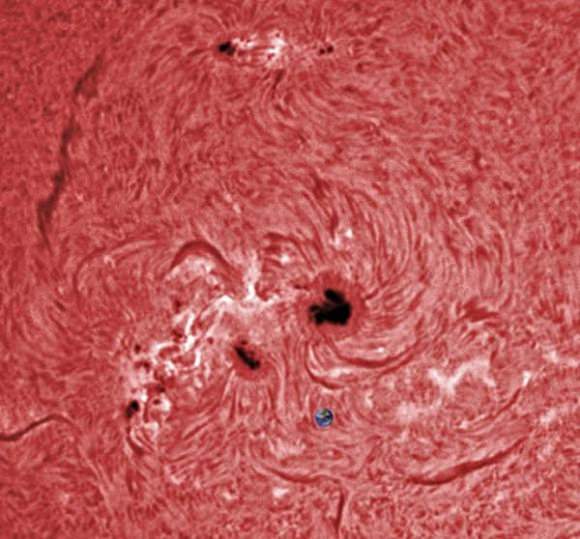 A closeup look at sunspot AR1944 on January 6, 2013, comparing its size to Earth. Credit and copyright:  Ron Cottrell. 